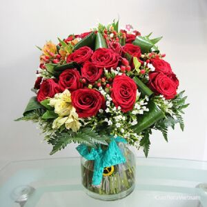 Red roses and seasonal flowers in vase